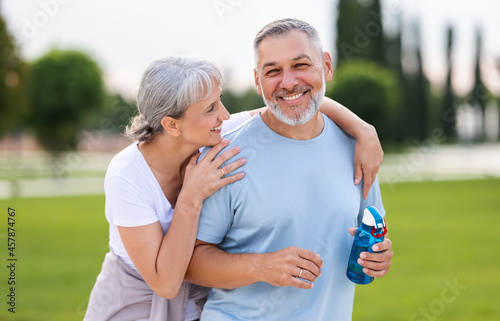 Portrait of lovely happy elderly couple on morning run outside in city park