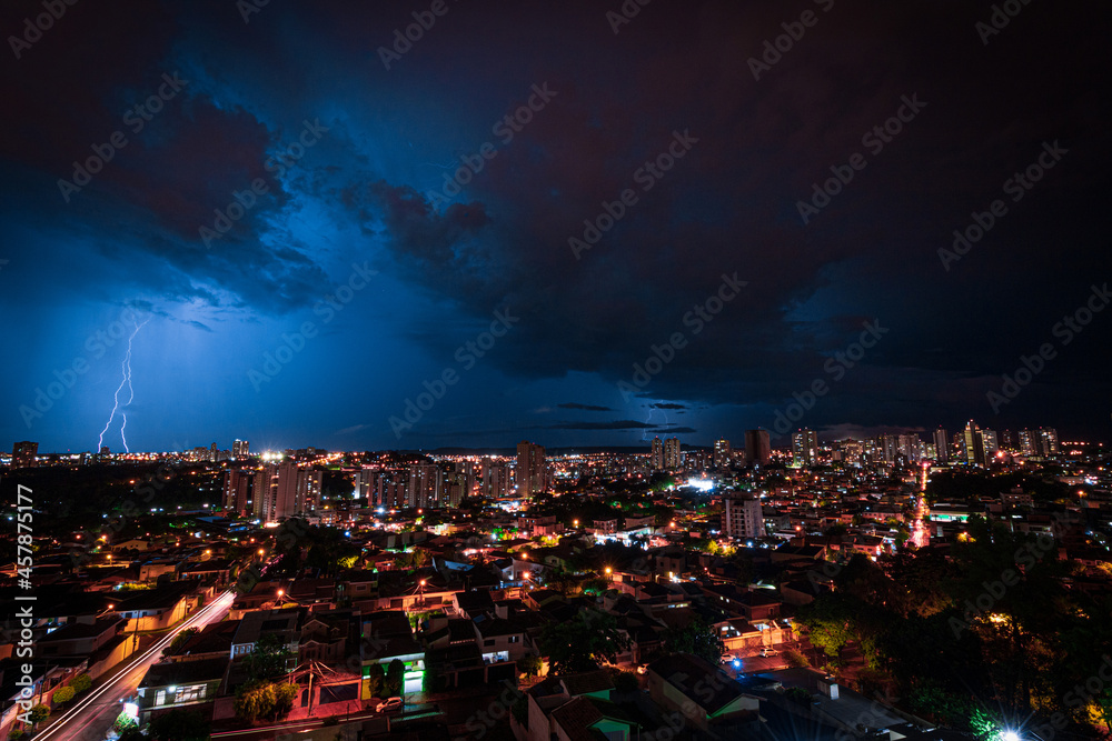 Obraz premium Lightning Storm Over Ribeirao Preto City in Brazil. Thunder blue light on a summer night concept image.