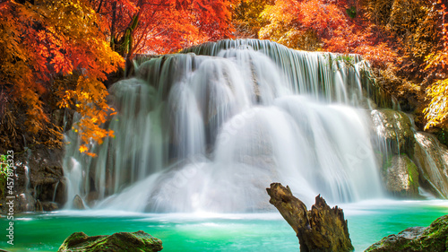 Amazing in nature  beautiful waterfall at colorful autumn forest in fall season.  