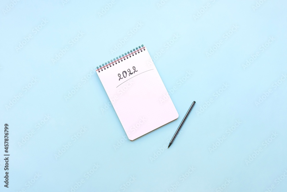 Top view of empty notebook ready for New 2022 Year resolutions or wish list.