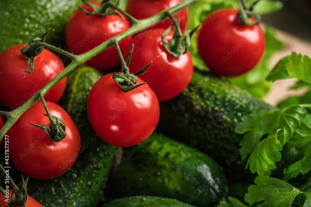 Vegetarian still life. Raw vegetables. Red tomatoes on a green background. Vegetarian still life. Raw vegetables. Red tomatoes on a green background.