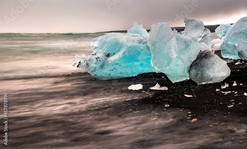 dramatic  and out of this world landscape of blue icebergs and diamond like ice  washed ashore in the black sands of Diamond Beach in south Iceland © Nathaniel Gonzales