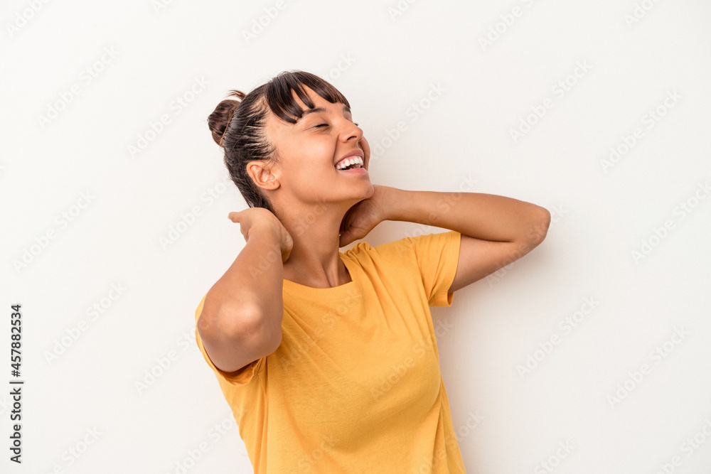 Young mixed race woman isolated on white background feeling confident, with hands behind the head. Young mixed race woman isolated on white background feeling confident, with hands behind the head.