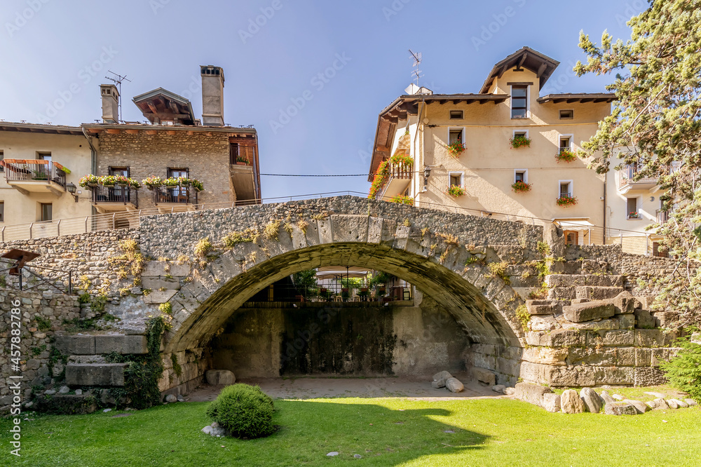The ancient Roman bridge over the Buthier in the old town of Aosta, Italy, on a sunny day