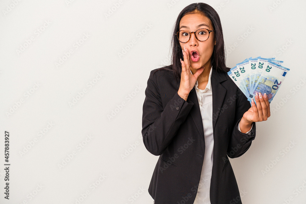 Young business latin woman holding bills coffee isolated on white background is saying a secret hot braking news and looking aside Young business latin woman holding bills coffee isolated on white background is saying a secret hot braking news and looking aside