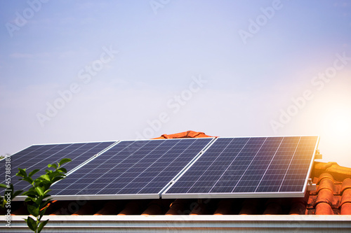 Solar panels on the red roof in a sunny and cloudy day. Photovoltaic instalation image. photo
