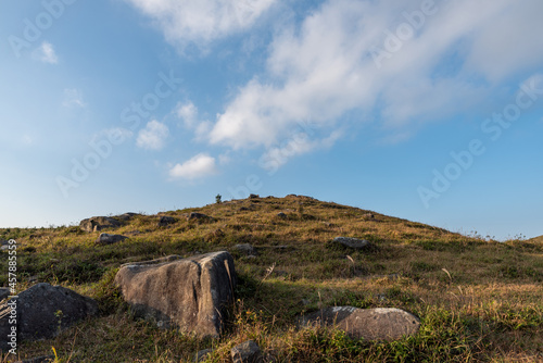 Stones on the plateau meadow under the blue sky © chen