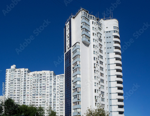 Multi-storey residential house with solar panels on the facade. Modern Ukrainian architecture