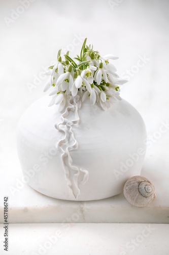 Bouquet of snowdrops flowers in white vase