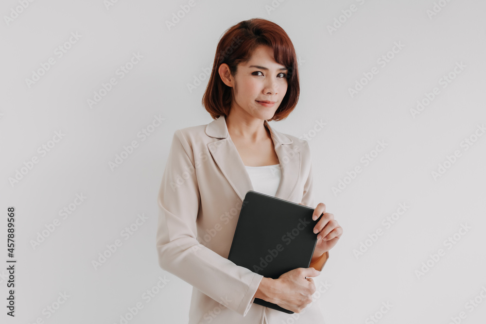 Fototapeta premium Confident Asian business woman hold a tablet isolated on white background.