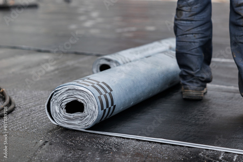 Closeup of Rolls of new black roofing felt or bitumen. Selective focus