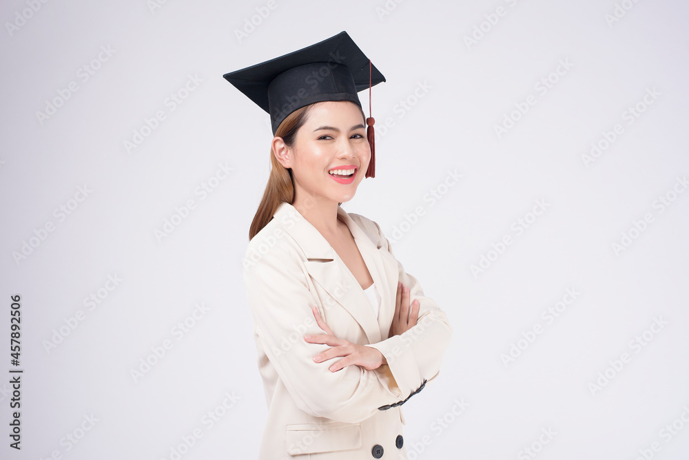 Portrait of young woman graduated over white background. Portrait of young woman graduated over white background.