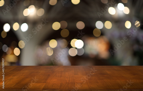 Empty wooden table in front of abstract blurred background of coffee shop . can be used for display or montage your products.Mock up for display of product