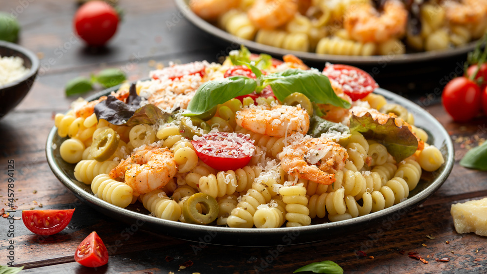 Prawn pasta salad with marinated green olives, cherry tomatoes and parmesan cheese.