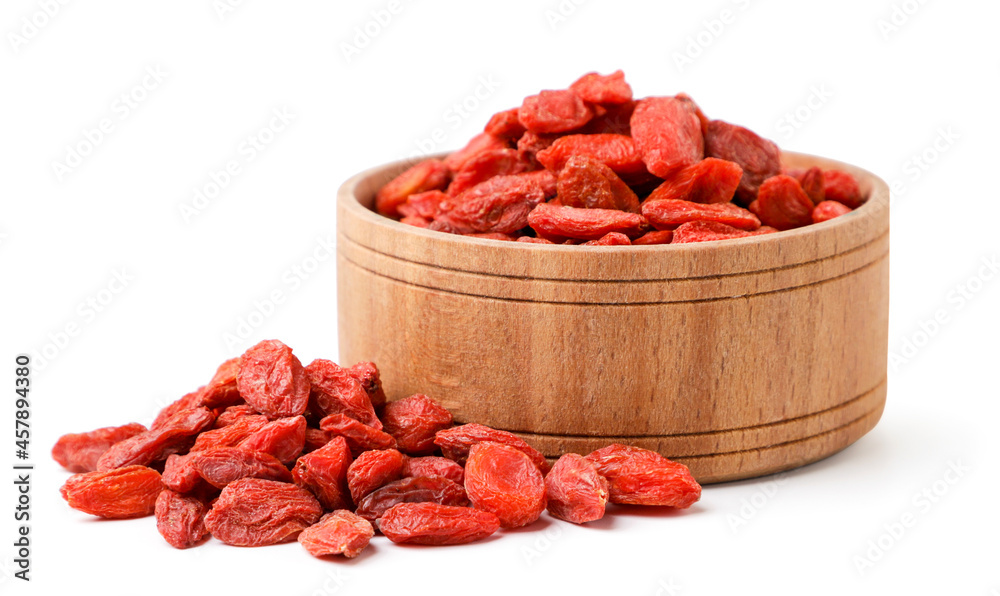 Dry goji berries in a wooden plate on a white background. Isolated Dry goji berries in a wooden plate on a white background. Isolated