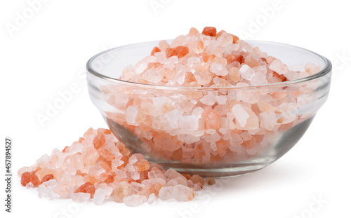 Himalayan pink salt in a transparent plate on a white background. Isolated
