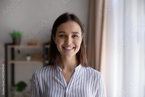 Head shot portrait confident businesswoman, successful entrepreneur, student looking at camera, happy beautiful young woman with healthy toothy smile posing for profile picture, standing at home Free Download Head shot portrait confident businesswoman, successful entrepreneur, student looking at camera, happy beautiful young woman with healthy toothy smile posing for profile picture, standing at home - GFXLoad