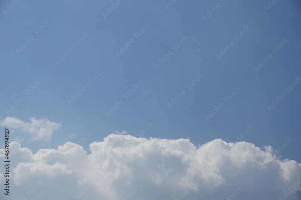a sea of white clouds in a clear blue sky
