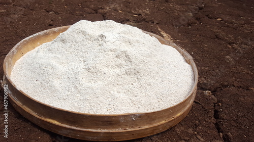 cassava flour in a bamboo basket on dry ground.Manihot esculenta, commonly called cassava, manioc,or yuca