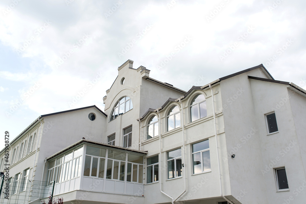 building against the backdrop of a dramatic sky with clouds