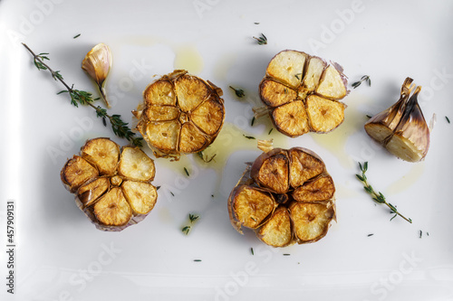 Roasted garlic with thyme and oil, top view