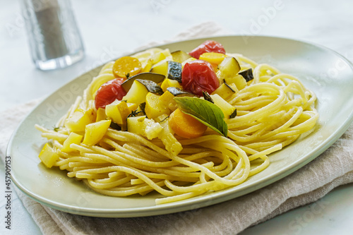 Spaghetti with steamed zucchini and tomatoes and sauce