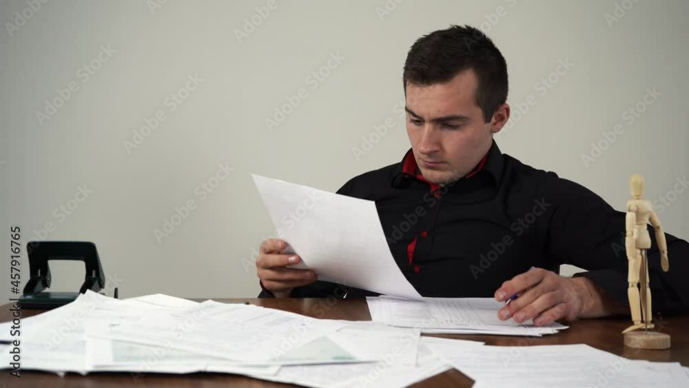 man studying documents sitting at a table 4k footage man studying documents sitting at a table 4k footage
