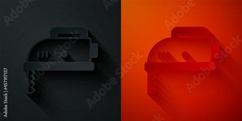 Paper cut Electric jigsaw with steel sharp blade icon isolated on black and red background. Power tool for woodwork. Paper art style. Vector