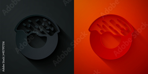 Paper cut Donut with sweet glaze icon isolated on black and red background. Paper art style. Vector