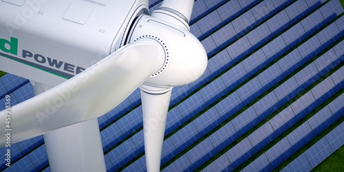 Large wind turbine seen from above with solar field in the background.  photo