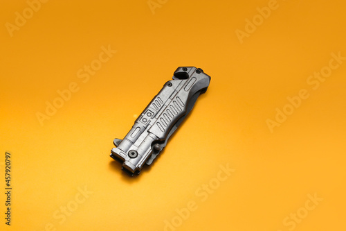 Stainless Folding Knife isolated on orange background