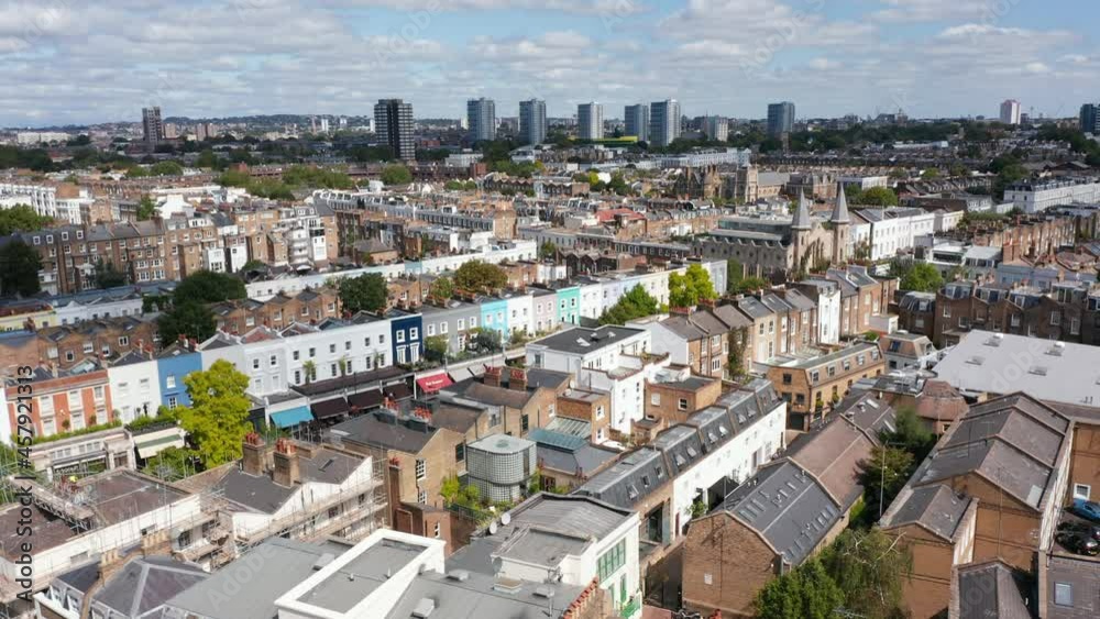 Rising shot of urban buildings. Residential district of large city. Group of tall apartment houses in background. London, UK Rising shot of urban buildings. Residential district of large city. Group of tall apartment houses in background. London, UK
