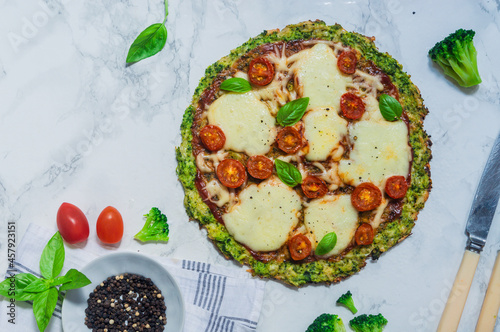 broccoli pizza crust with cherry tomatoes and mozzarella cheese photo