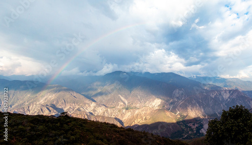 The rainbow over the Chicamocha s Canyon on a sunny and rainy afternoon