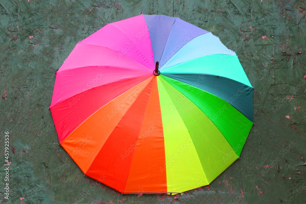Selective focus, eye-catching colorful street parasol of vibrant rainbow-like colors