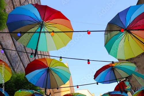Selective focus, eye-catching colorful street parasol of vibrant rainbow-like colors © Emrah