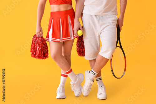 Cheerleader and tennis player on color background