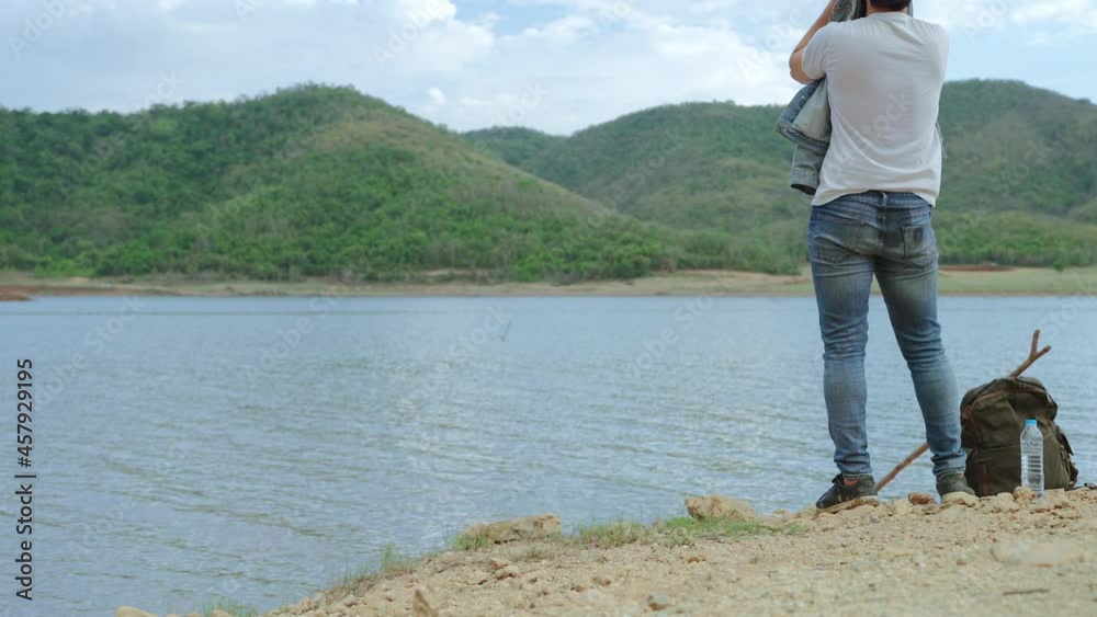 Survivalists are vacationers drinking water by the lake after a long day of travelling.
Survivalists are vacationers drinking water by the lake after a long day of travelling.