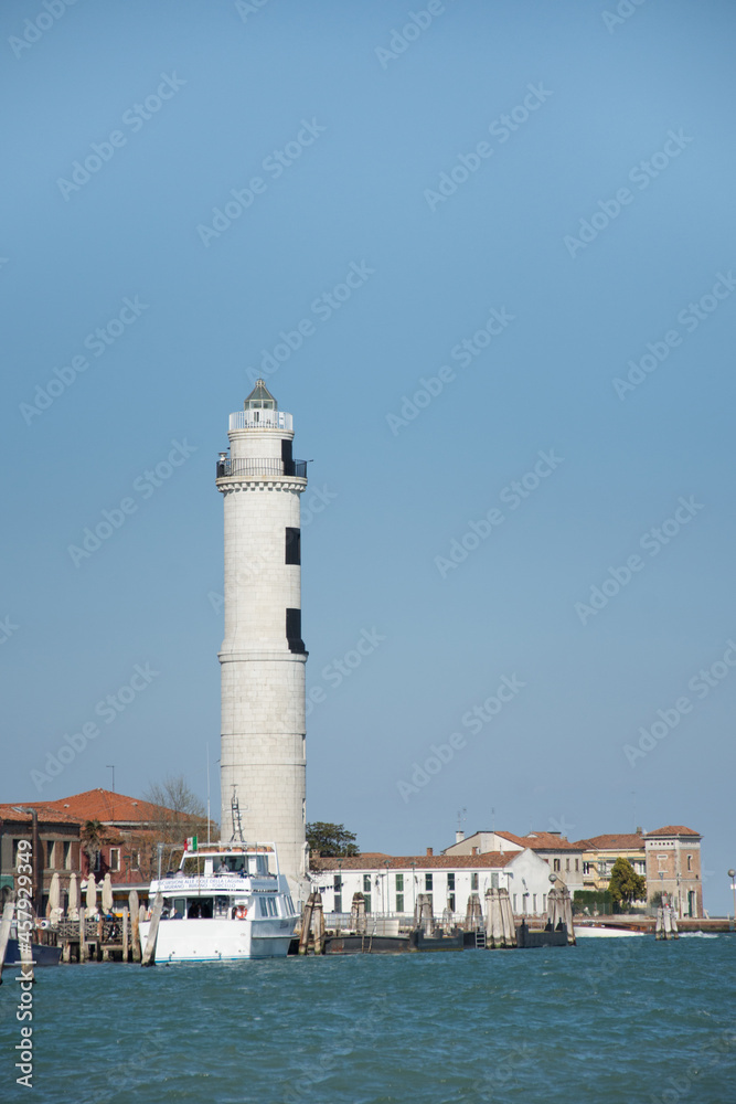 Laguna brick buildings and lighthouse of Murano in Venice in Italy.,2019