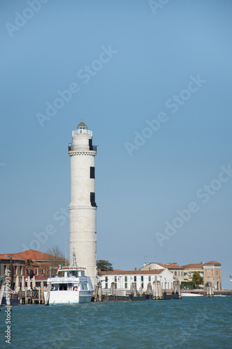 Laguna brick buildings and lighthouse of Murano in Venice in Italy.,2019