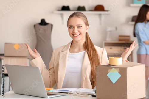 Female business owner processing order in shop