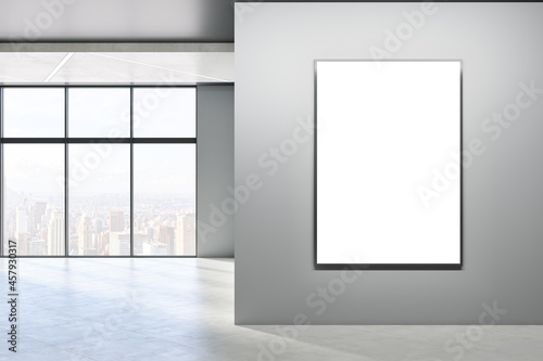 Modern empty concrete room interior with blank mock up frame on wall  windows  city view  sunlight and shadows. 3D Rendering.