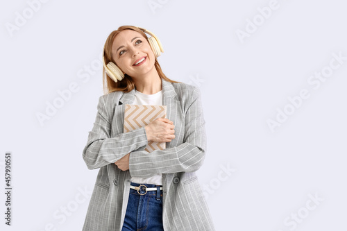 Mature woman with headphone...