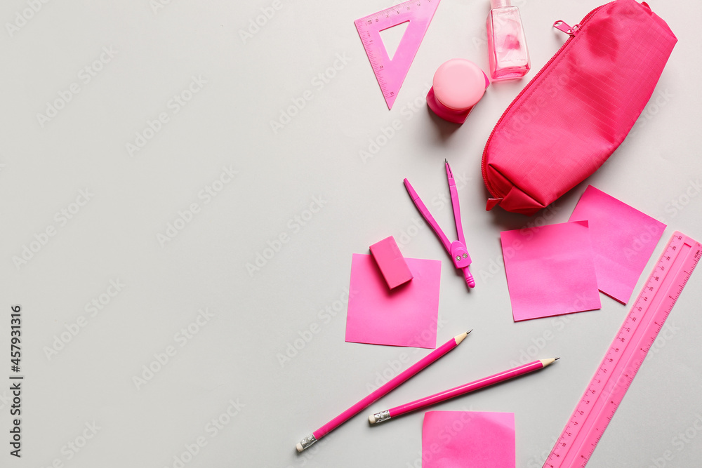 Pencil case with stationery and bottle of sanitizer on light background Pencil case with stationery and bottle of sanitizer on light background