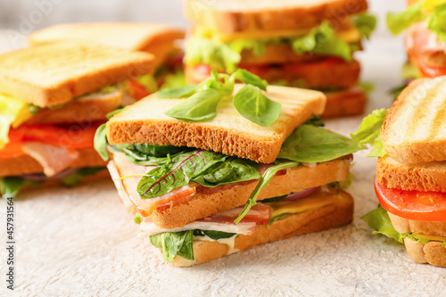 Tasty sandwiches on light background, closeup