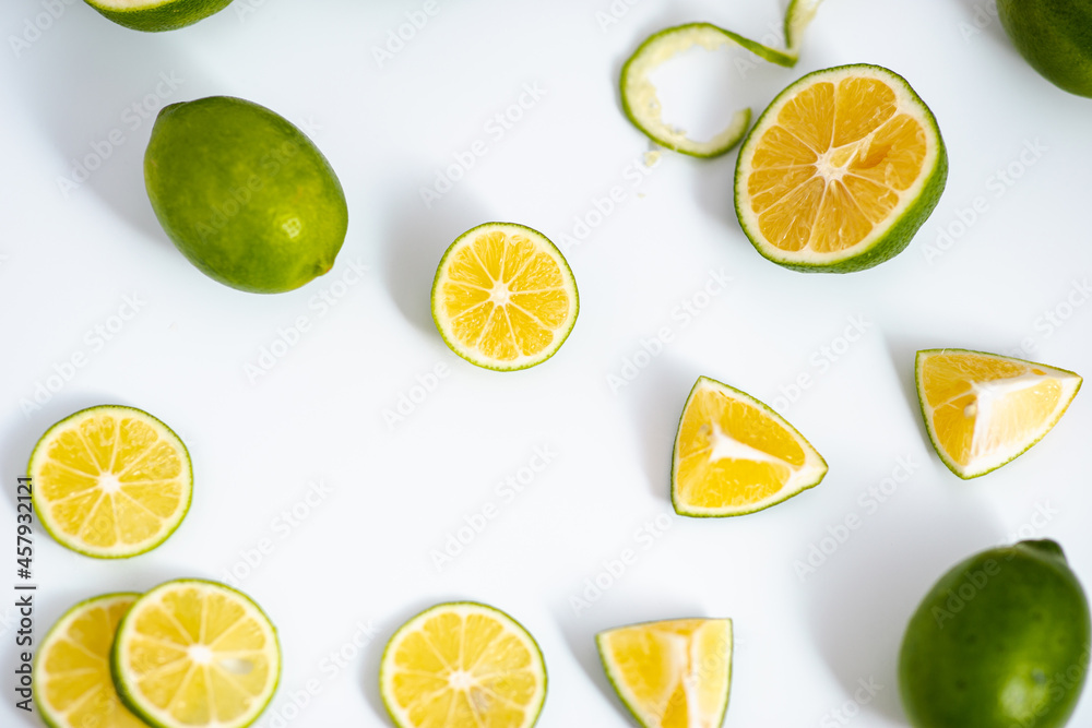 Flat lay view green lime lemons over isolated white backdrop.Includes copy space. Flat lay view green lime lemons over isolated white backdrop.Includes copy space.