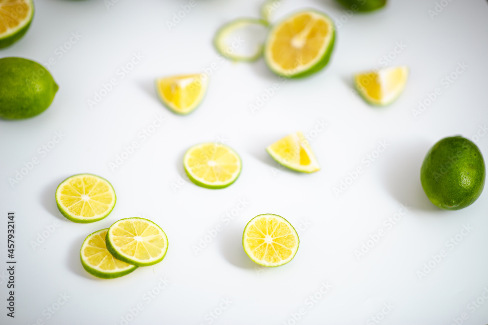 Closeup detail view green lime lemons over isolated white backdrop.Includes copy space.