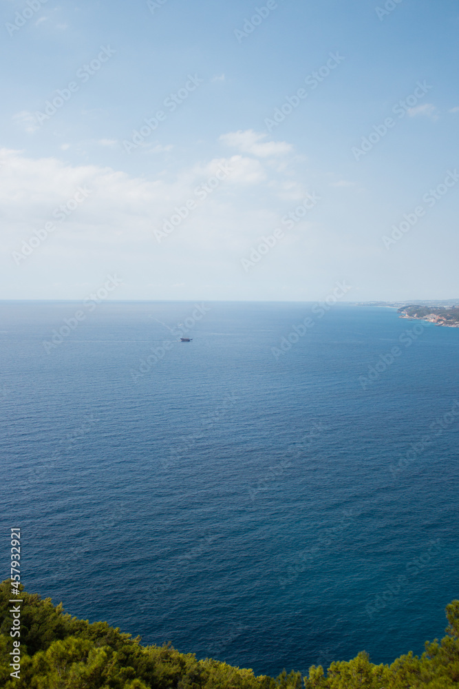 Sea view from above. View from the castle. Ship at sea in the distance.