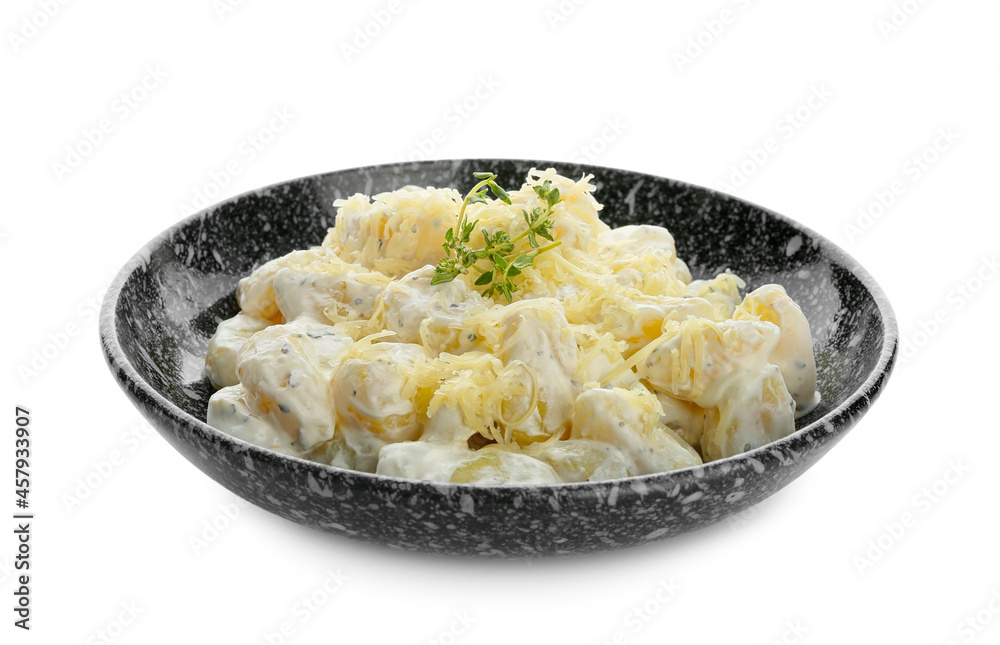 Bowl of delicious gnocchi with creamy sauce on white background