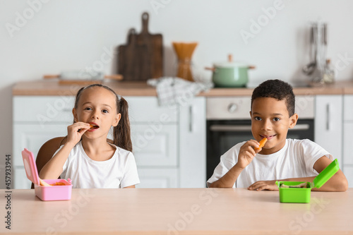 Cute children having lunch ...